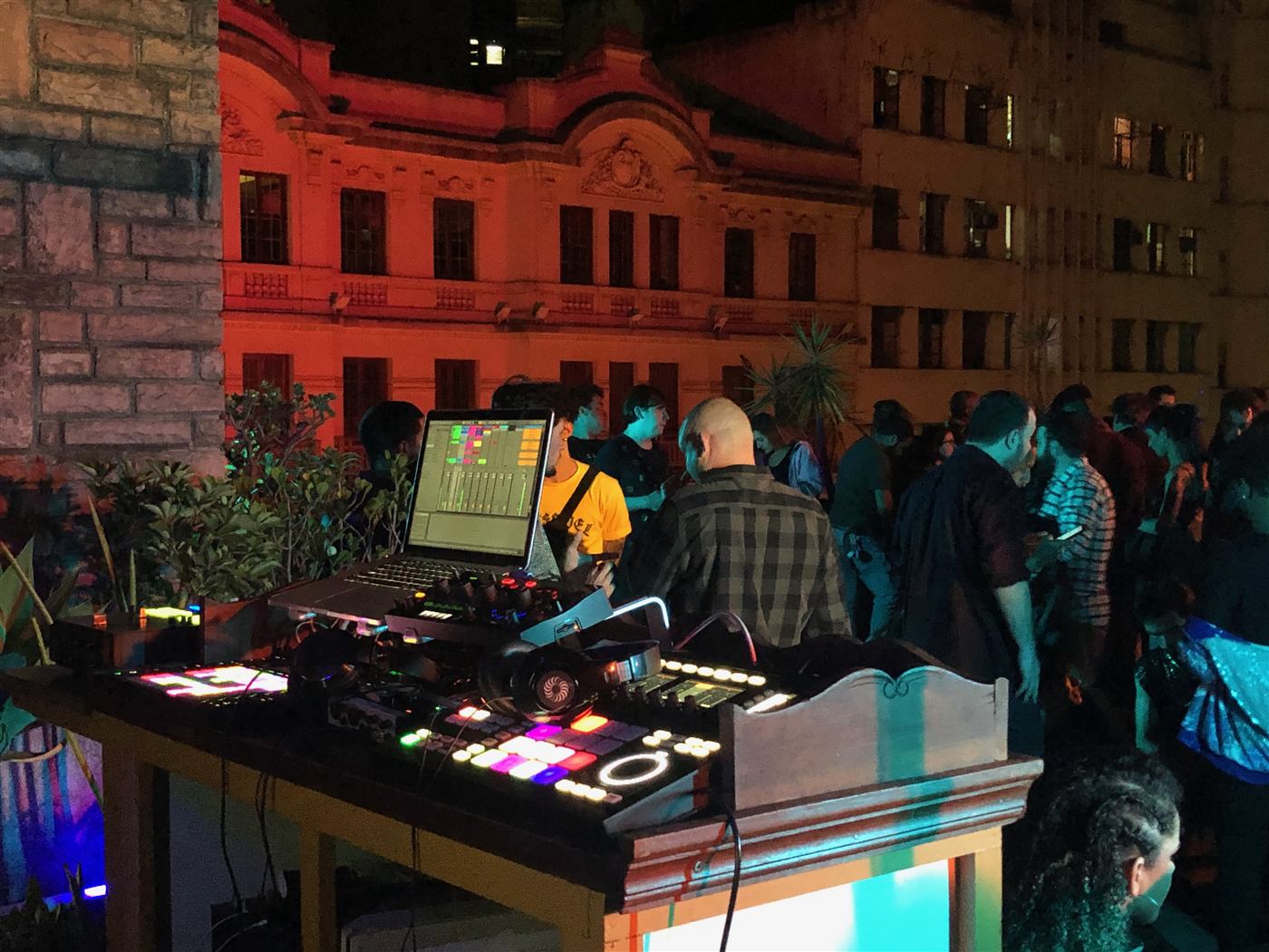DJ tocando para o público em evento noturno no centro de São Paulo
